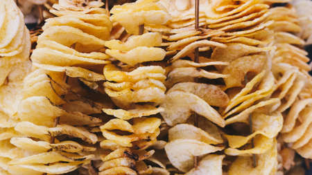 A pile of fried potatoes in the snack marketの写真素材
