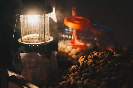 Uplik or teplok lamp with wedhang ronde beside it. Teplok is a traditional lamp with keroseneの写真素材