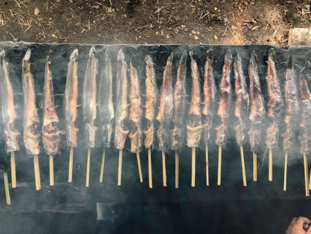 Cat fish barbecue grilled on hot charcoal stove in traditional way in Yogyakarta, Indonesia or normally called Mangut lele.の写真素材