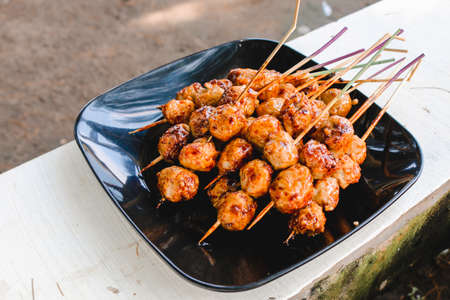 Cooking Barbecue Meatball Satay in grilling stove. This is Indonesian Traditional Street Food made from meatball.のeditorial素材