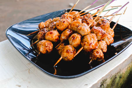 Cooking Barbecue Meatball Satay in grilling stove. This is Indonesian Traditional Street Food made from meatball.の写真素材