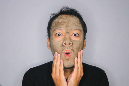 Wow Asian Man was shock and look at the camera when he use beauty face maskの写真素材