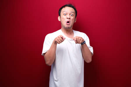 Angry and stress young Asian man raising his arm up.の写真素材