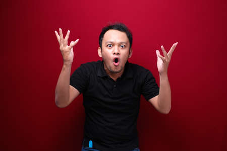 Wow and shocked face of Young Asian man with open hand gesture. Advertising model concept.
