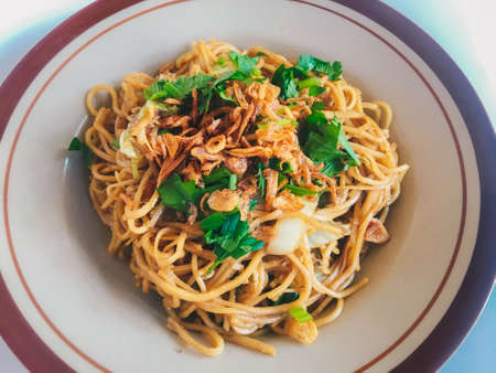 Mie Goreng Jawa or bakmi jawa or java noodle. Indonesian traditional street food noodles from central java or Yogyakarta, indonesia on white background.の写真素材