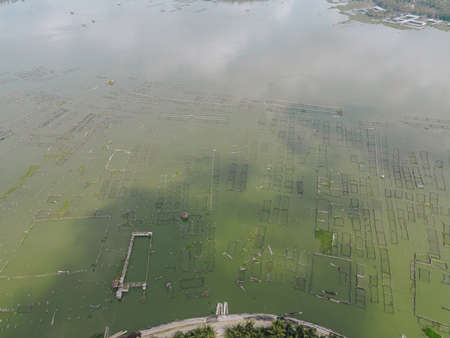 Top aerial view of traditional floating fish pond on swamp in Indonesia