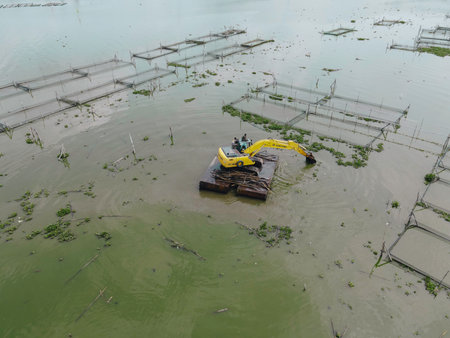 aerial view of crane in traditional floating fish pond on swamp in Indonesiaのeditorial素材