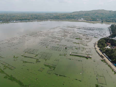 Aerial view of traditional floating fish pond on swamp in Indonesia