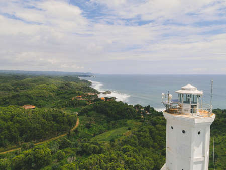 Aerial view of Baron beach in Yogyakarta, Indonesia with lighthouse and traditional boats