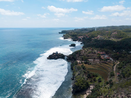 Aerial view of Beautiful beach in Gunung Kidul, Indonesia in daylight.の写真素材