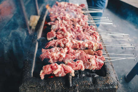 Raw Goat Satay Klathak making process on a charcoal grill.の写真素材