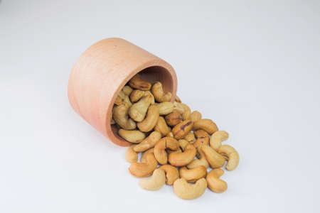 Cashew Nut, in Indonesia known as Kacang Mete. Served in a small bowl on white background.