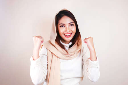 Beautiful muslim woman enthusiast, celebrating, yes. Success conceptの写真素材