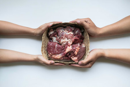 The top view of giving of sacrificial meat on Eid al-Adha isolated by white background