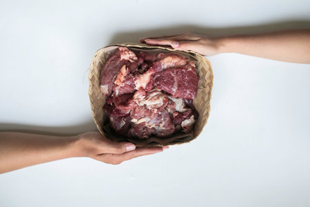 The top view of giving of sacrificial meat on Eid al-Adha isolated by white background