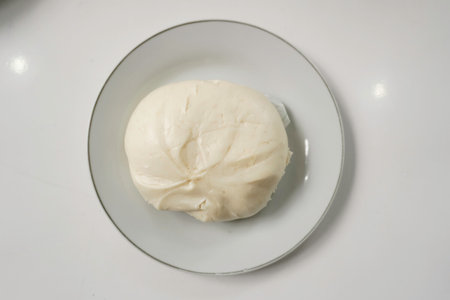 bao zi or bapao,bakpao-Chinese steamed buns,served on a plate isolated by white backgroundの写真素材