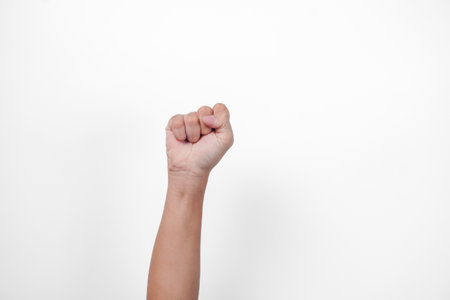 Portrait of a hand making fist as a win, success, victory gesture, on isolated white backgroundの写真素材