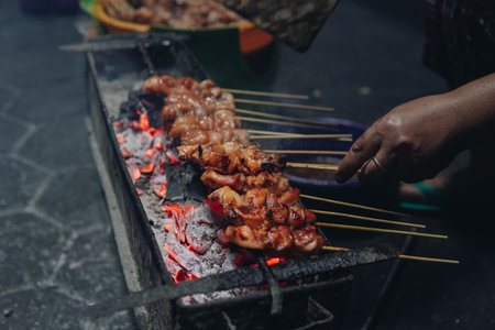 The process of making Indonesian chicken satay in traditional way using charcoal, tasty Asian cuisine.の写真素材