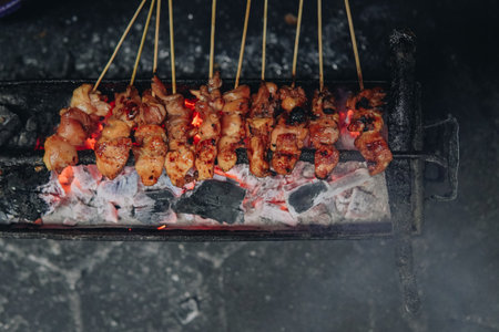 The process of making Indonesian chicken satay in traditional way using charcoal, tasty Asian cuisine.の写真素材
