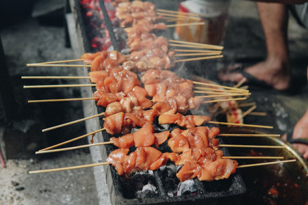 The process of making Indonesian chicken satay in traditional way using charcoal, tasty Asian cuisine.の写真素材
