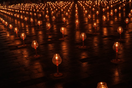 A large number of candles are lit for Vesak Day ceremony in Borobudur Temple. The candles are arranged in a grid pattern, with some candles placed closer together and others spaced further apart.の写真素材