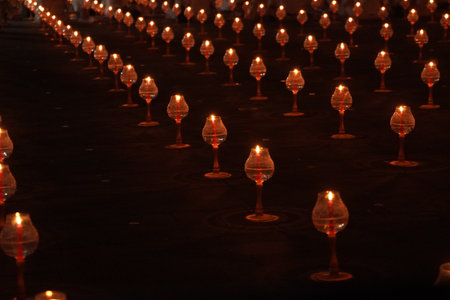 A large number of candles are lit for Vesak Day ceremony in Borobudur Temple, arranged in a long line.の写真素材