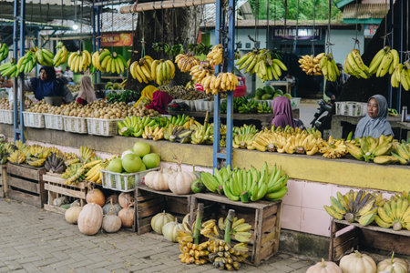 Vibrant street market stall brimming with fresh and colorful fruits neatly displayed in plastic and...
