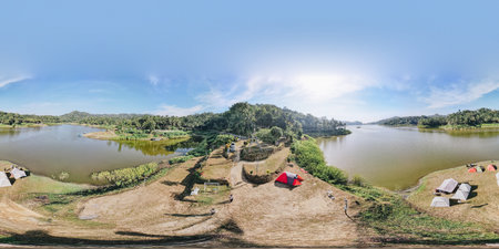 A 360 view panoramic shot of a Sermo lake in Kulon Progo, Yogyakarta, Indonesia, with some tents by the lake.の写真素材