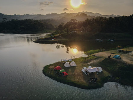 Aerial morning view of camping ground area by the Sermo Lake with forest hill on the background in Kulonprogo, Yogyakarta, Indonesia.の写真素材