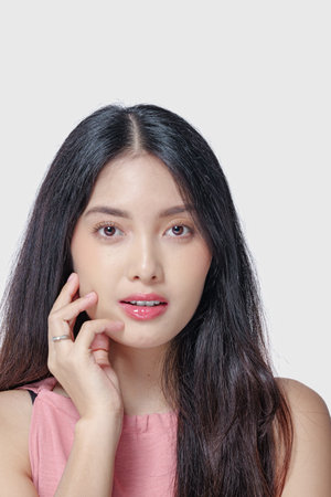 Elegant young Asian woman with beautiful make up doing a chic pose isolated by white background.の写真素材