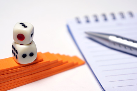 Dices with pen and notepad for business conceptの写真素材