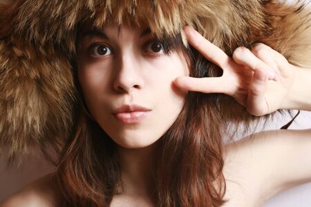 Portrait of the beautiful girl in a fur cap close up.の写真素材