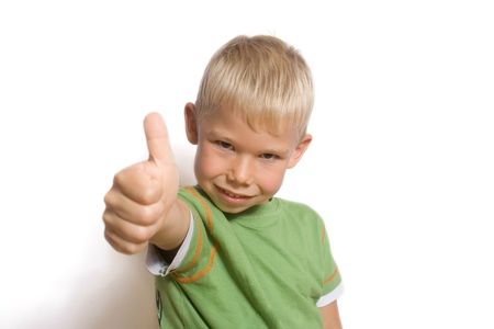 Portrait of the boy lifting the big finger of a hand upwards.