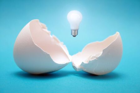  From the broken egg the shone lamp is pulled out.の写真素材