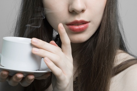 Portrait of beautiful woman drinking coffee の写真素材