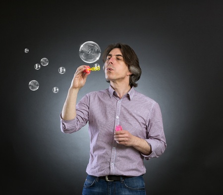 A man inflates soap bubbles 