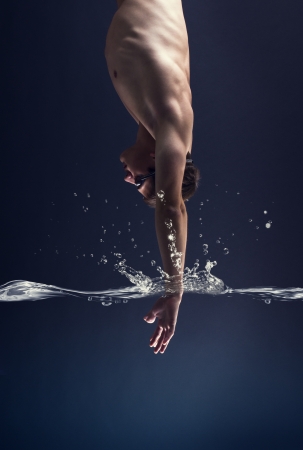 swimmer jumps into the water