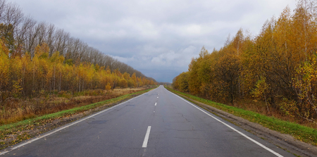 Landscape with a highway in the autumn dayの写真素材