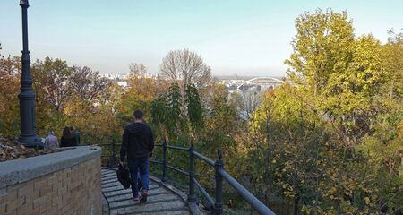 Autumn walk of people in the Vladimirskaya Gorka park in Kiev. Downhill stairs downの写真素材