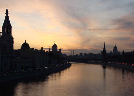 Silhouettes of buildings against the background of the evening sky in Moscow. Moscow river viewの写真素材
