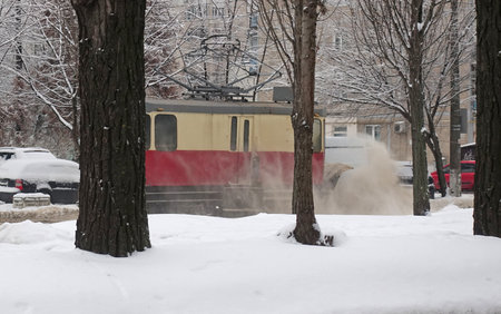 A tram clears snow from its tracks in winterの写真素材
