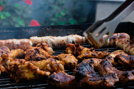 Marinated meat, chicken, ribs and sausages put on the barbecue
