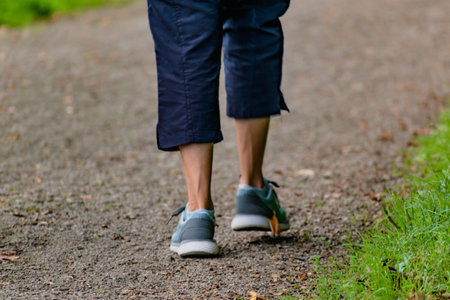 Woman with running shoes walking on a path, helathy activity to make exerciseの写真素材