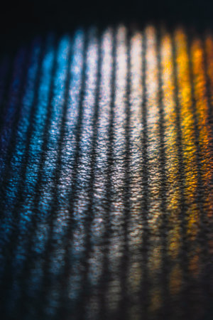 Sun catcher, prism of light on the ground through a grid reflected by a corner of a mirror