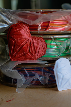 Spools of pla filament for printing 3d printer with printed models, material coils