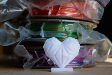 Spools of pla filament for printing 3d printer with printed models, material coilsの写真素材