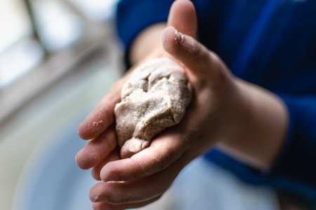 Child having fun modeling dough, authentic activity for fine motor skills developmentの写真素材