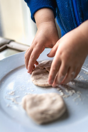 Child having fun modeling dough, authentic activity for fine motor skills developmentの写真素材