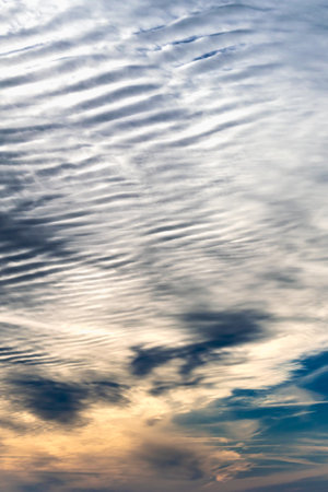 Beautiful striated cloud formation in sky looking like fluffy waves, weather forecast