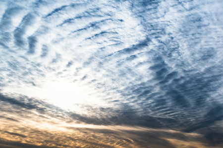 Beautiful striated cloud formation in sky looking like fluffy waves, weather forecastの写真素材